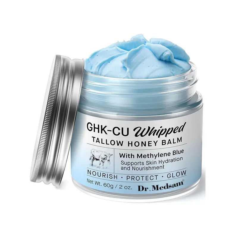 Silver jar of GHK-Cu Whipped Tallow Honey Balm with blue Methylene Blue cream inside, supporting skin hydration and nourishment
